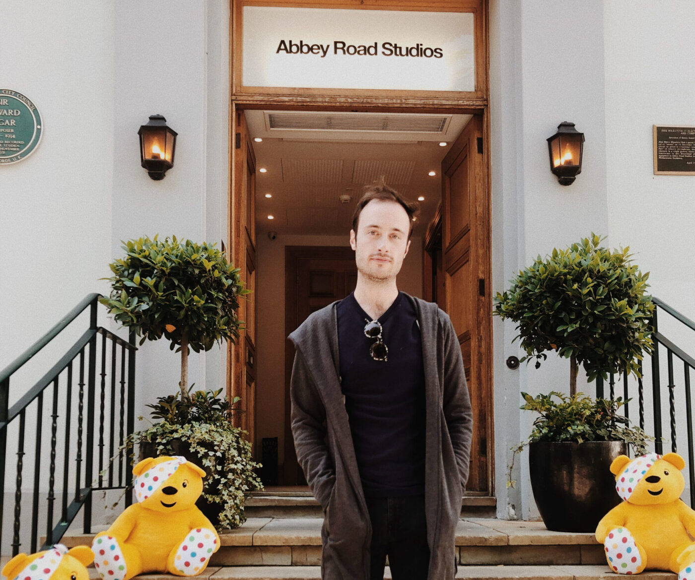 Artist standing in front of Abbey Road Studios on steps