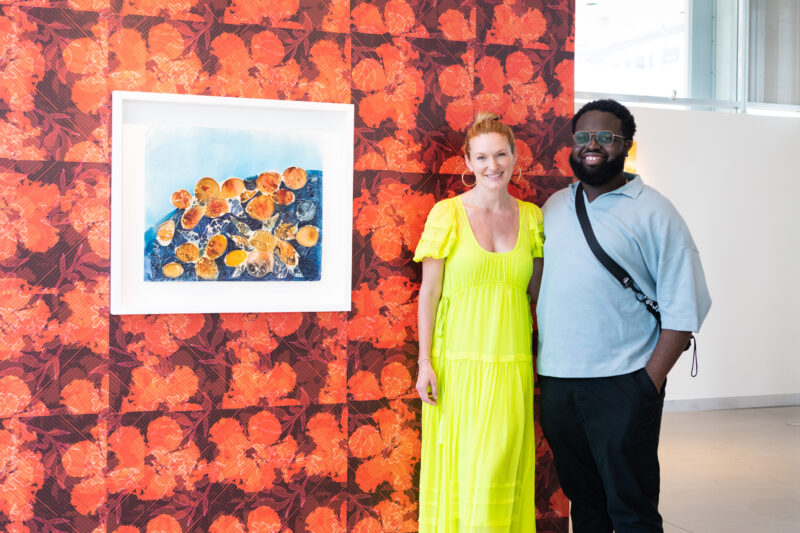 Sarah Arison and Mark Fleuridor (2015 Visual Arts & U.S. Presidential Scholar in the Arts) at a solo exhibition of Fleuridor's works in the YoungArts Gallery during 2022 Art Basel Miami Beach. Photo by World Red Eye.