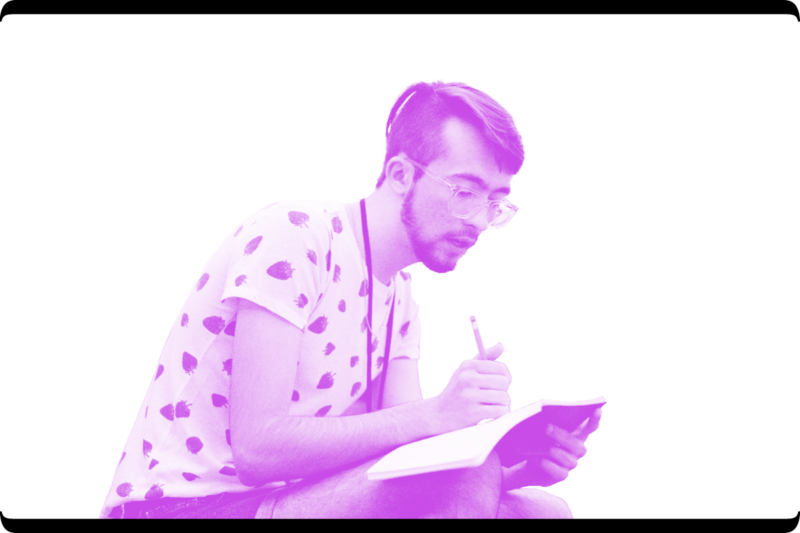 Young man writing in a notebook