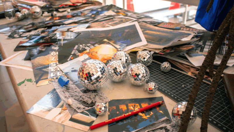 Table with art materials and small disco balls